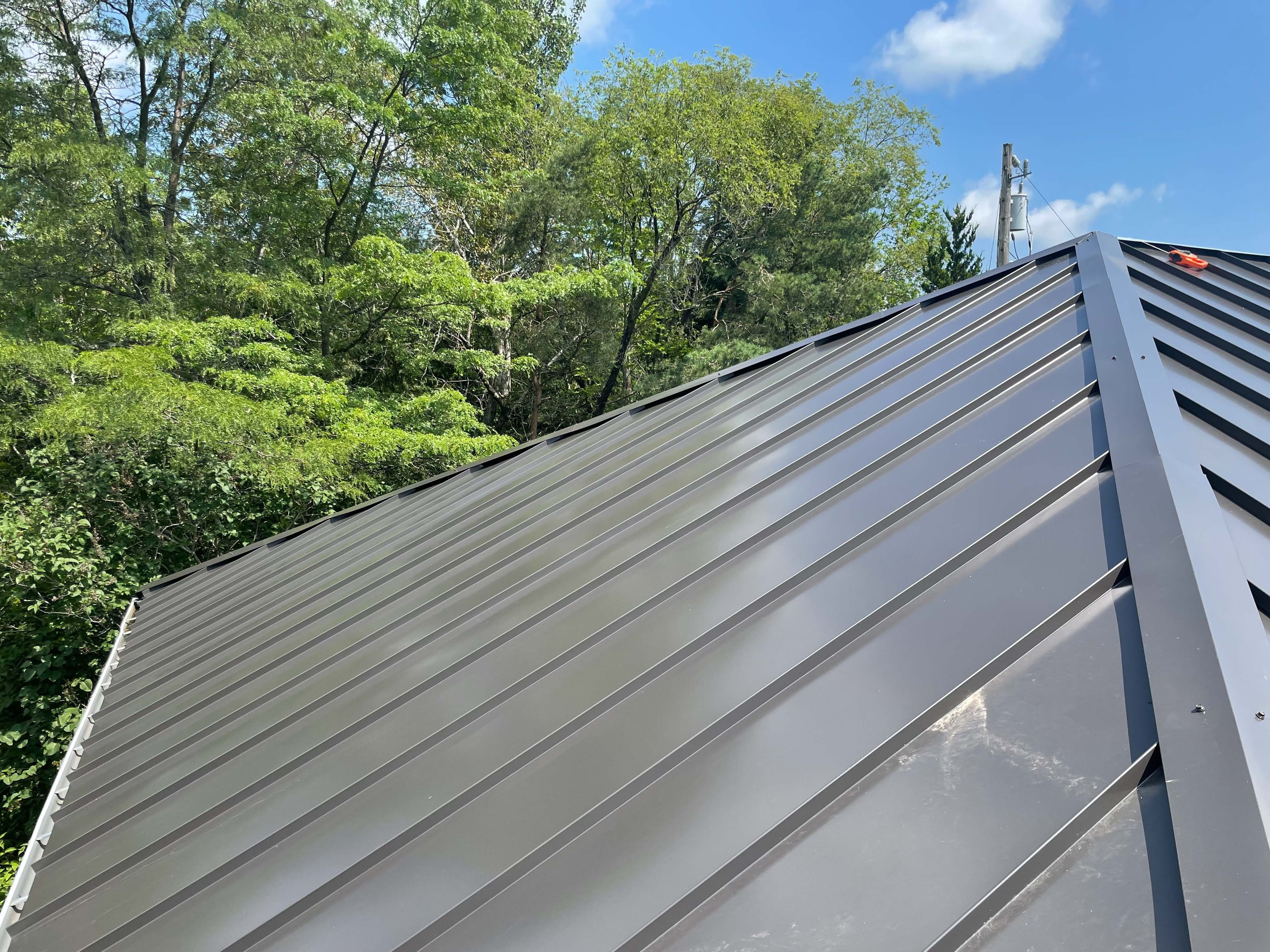 Standing seam metal roofing — ridge and hip detail, GTA
