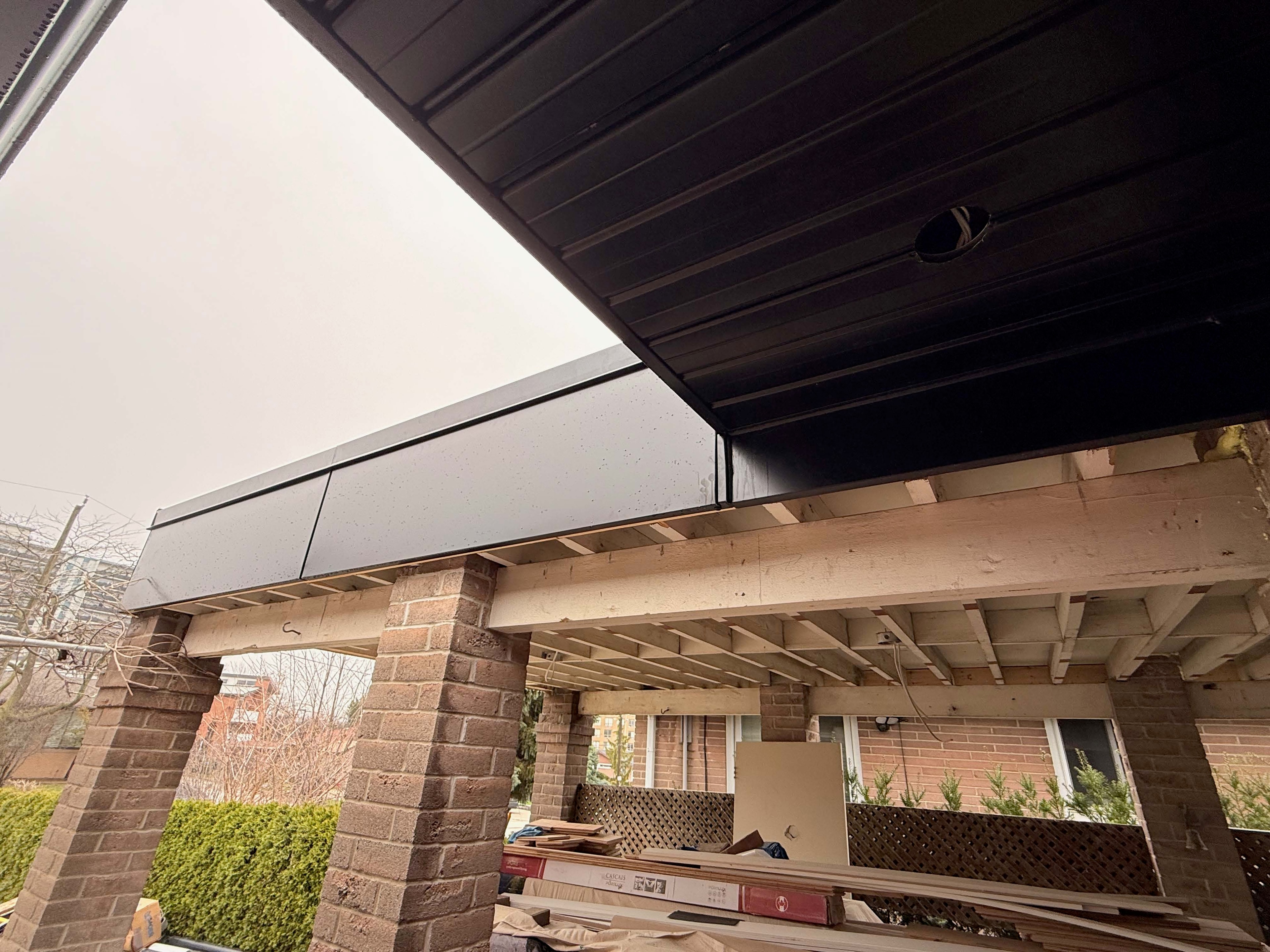 Metal siding and cladding — dark corrugated panels, rooftop screen wall, GTA